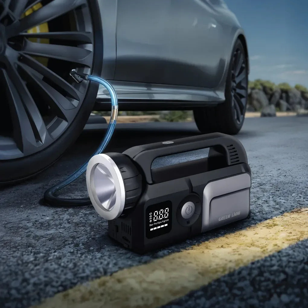 Gray Green Lion Savior 12V jump starter for 8L gas and 6L diesel engines, showing the portable device with cables and display panel.
