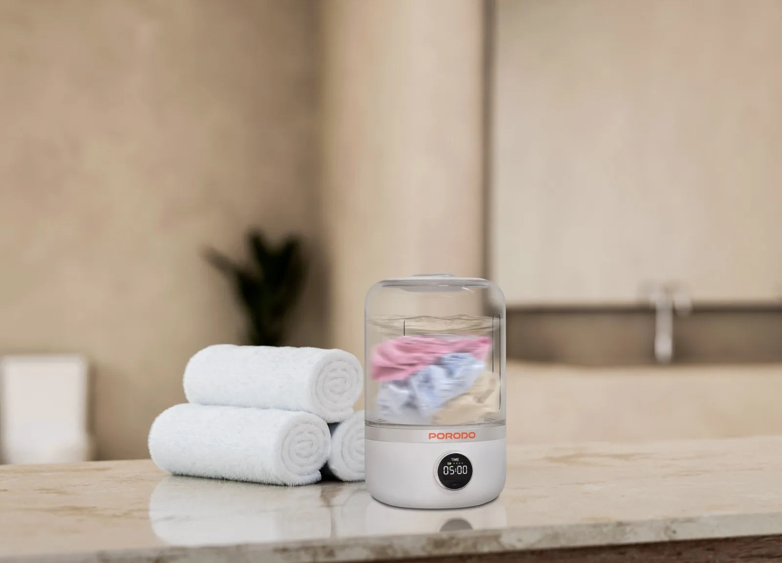 Porodo Mini Laundry Cup 1.2L washing machine with 4000mAh battery and 10W power, showcasing compact design and features.