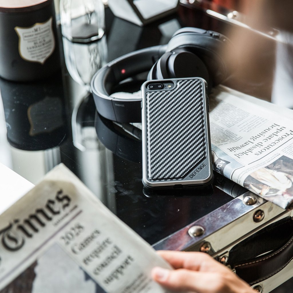 Aukey B25 with XDoria Defense Lux case, showcasing black carbon fiber design for iPhone 7 Plus, highlighting durability.