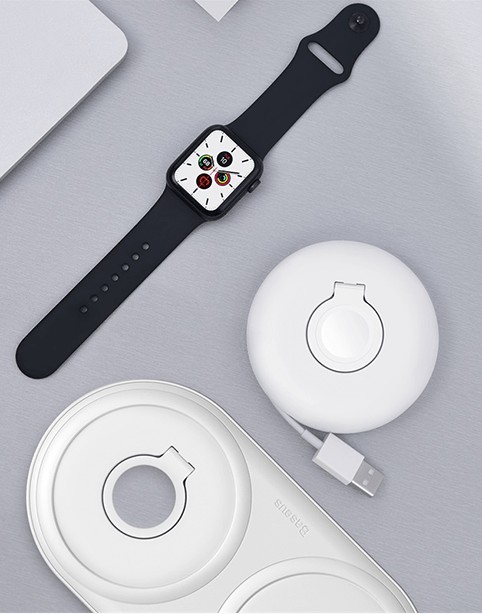 White Baseus Planet cable winder for Apple Watch shown coiled around the watch, designed to keep charging cables organized.